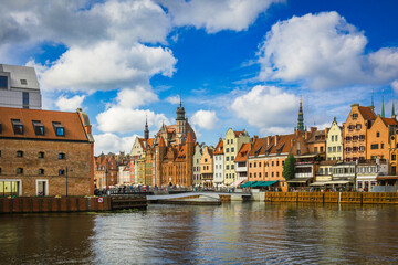 Fototapeta premium Beautiful city of Gdansk in the margins of the Motlawa river with the touristic boats and coloured buildings