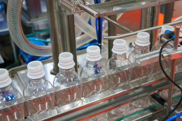 The  empty drinking water bottles  on the conveyor belt for filling process.