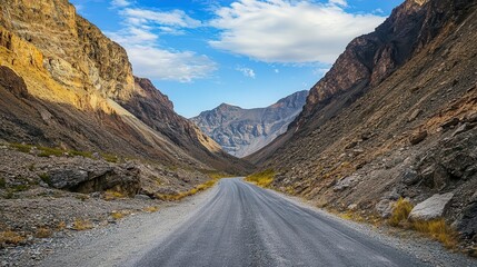 Mountain pass road with towering peaks on both sides, Rugged journey exploration