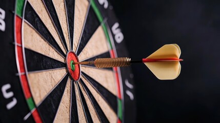 A close-up of a dart hitting the bullseye on a dartboard, symbolizing precision and success in sports.