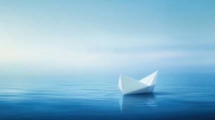 Obraz premium A single paper boat floating on calm blue ocean waters surrounded by light mist drifting into the unknown horizon
