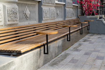 A long wooden bench with a table attached to it