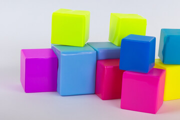 Obraz premium Colored cubes on a white. Cube color concept. A group of colored cubes on a white . A white with colored cubes and toys lifestyle.