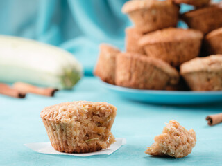 Close up view of muffin with zucchini, carrots, apple and cinnamon on blue concrete background. Sweet vegetables homemade muffins. Toddler-friendly recipe idea. Copy space. Shallow DOF