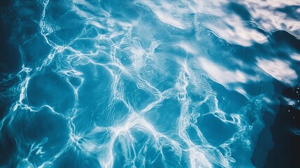 Fototapeta premium A serene view of clear blue water with shimmering reflections, perfect for relaxation and tranquil imagery.