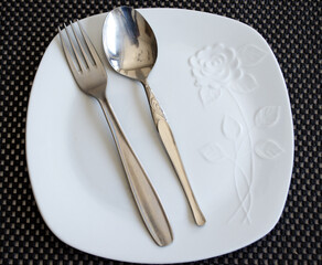 empty plate and cutlery set on a table