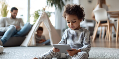 Curious toddler playing with a tablet in a cozy living room, while family enjoys quality time in the background