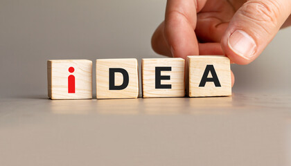 Creative Idea Concept with Wooden Cubes Spelling IDEA, Hand Arranging Blocks with Red I Symbol,...