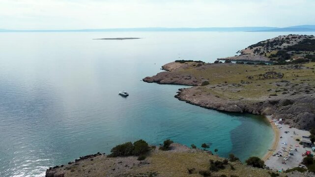 Slow Forward Drone View of Motor Yacht and Turquoise Beach Cove in Stara Ba&scaron;ka, Krk Island, Croatia