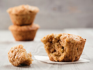 Close up view of muffin with zucchini, carrots, apple and cinnamon on gray wooden background. Sweet vegetables homemade muffins. Toddler-friendly recipe idea. Copy space. Shallow DOF