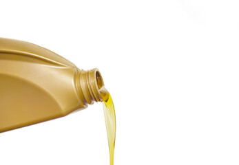 Pouring engine oil from a yellow bottle isolated on white background. Changing the engine oil in a...