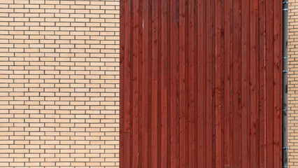 A striking juxtaposition of red wood and beige brick creating architectural interest.