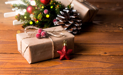 Christmas decoration on wooden table. Celebration gift, pine cone and tree. 