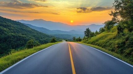 Naklejka premium A serene road leading through lush mountains, bathed in the warm hues of sunset. Nature's beauty captures the essence of tranquility.