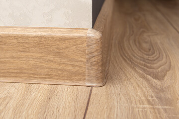 The outer corner for skirting board. Place of skirting board junction