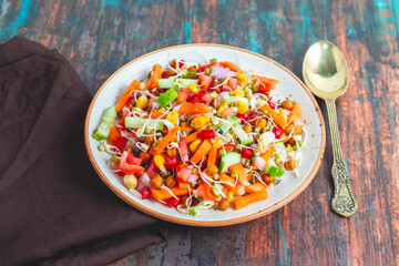 A vibrant, nutrient rich salad combining fresh greens, crisp vegetables, tangy dressings, crunchy toppings, and balanced Flavors for refreshment.