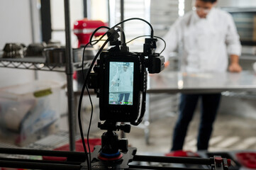 Pastry chef making desserts in front of a live camera.