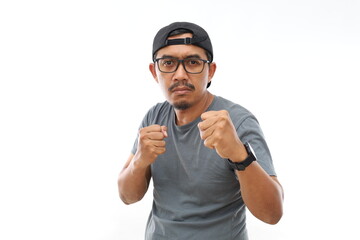 Fototapeta premium Asian man standing over isolated white background Ready to fight with fist defense gesture
