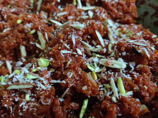 Carrot pudding Garnished with  almond, Raisin, and pistachio. Gajar ka halwa an Indian style dessert made of sweet with carrots. It's a sweet dessert made from carrots, sugar, and clarified butter. 