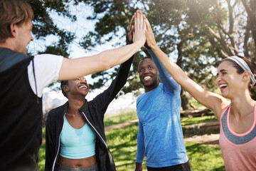 Fitness, couple of friends and high five at park for exercise with unity, celebration and solidarity. People, outdoor and happy or smile with huddle at forest in support for health and self care