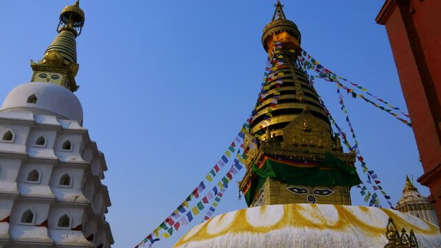 Wide angle shot of UNESCO world heritage site Swayambhunath Stupa, a Buddhist temple with colorful Tibetan prayer flags in Kathmandu Valley.