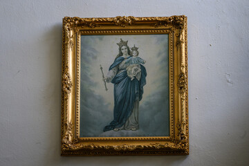 Painting of the Virgin Mary with Jesus Christ in a golden frame.
