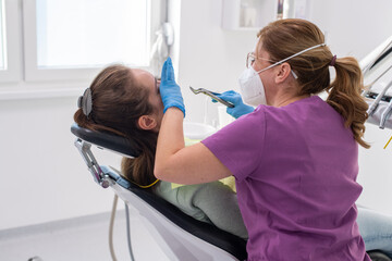 Tooth extraction using forceps closeup