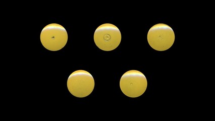 a set of yellow clear circles, empty stationery tacks, front view, isolated metal push rounded pins on black background
