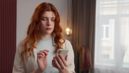 Disappointed shocked Caucasian girl female reading news messages online in mobile phone surprise wave head disagreement disapprove no gesture negative reaction refusal ban woman scroll screen at home