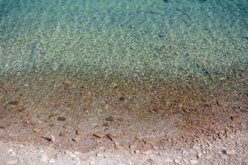 Clear marine water with rocky shore in Piran, Slovenia