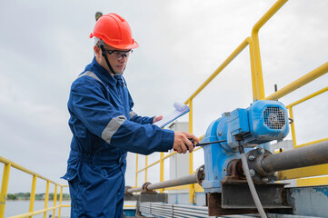 Water plant maintenance technicians, mechanical engineers check the control system at the water...