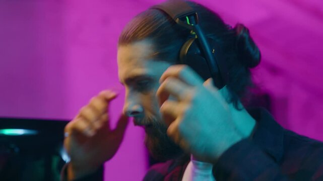Relaxed Caucasian man blogger prepare for stream virtual game tournament put on headphones influencer vlogger checking microphone sound male guy gamer speaking gaming session e-sport addiction at home