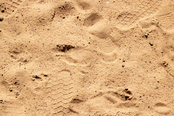 This is a close up view of a pile of sand with visible footprints in it