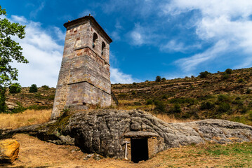 Fototapeta premium Belfry of the Rock church of Santo Justo and Pastor in Olleros de Pisuerga, Palencia, Spain, exterior view