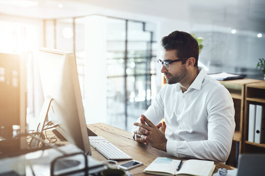 Business, man and reading computer at office on website or research and information. Lens flare, male person and concentration as employee with diary or notebook on internet as project manager