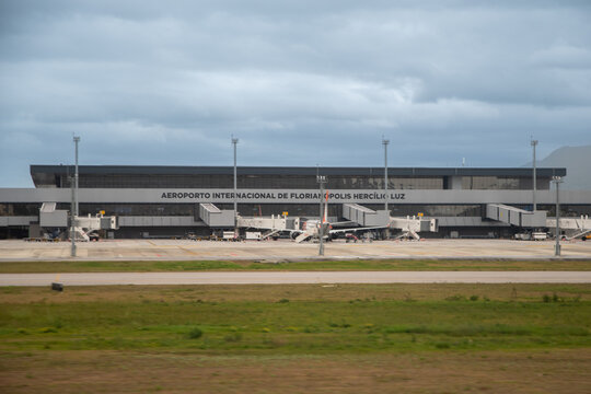 Hercilio Luz International Airport terminal and runway under a cloudy sky in Florianopolis, Brazil