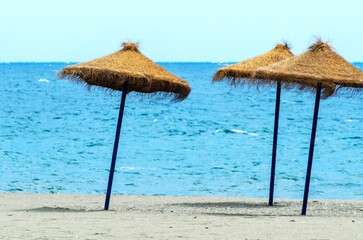 Beach umbrellas are on the beach