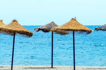 Beach umbrellas are on the beach