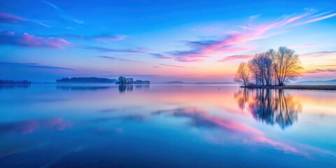 Obraz premium Pastel hues of blue and pink paint the sky at dawn in serene and tranquil landscape