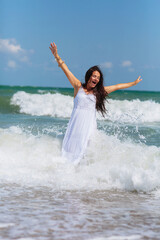 An elderly woman revels in the refreshing embrace of ocean waves, her laughter echoing along the...