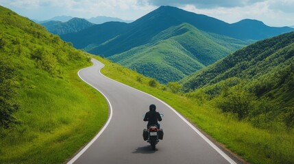 Fototapeta premium Rider Exploring Winding Mountain Road on Motorcycle