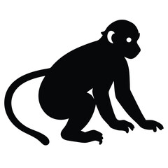 Obraz premium a black silhouette of a monkey. The monkey is sitting on its hind legs with its front paws on the ground and its tail curled around its body