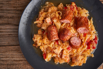 Cabbage stew with sausages and ham