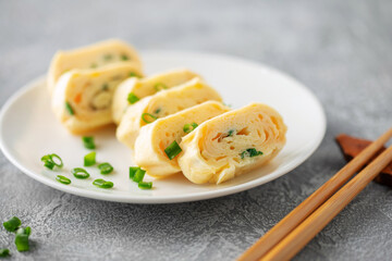 Tamagoyaki, Japanese rolled omelette in plate on the table