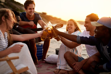 People, friends and bonding together for picnic or social by beach on holiday, vacation or break. Group, toast and fun with alcohol for summer season, wellness or outdoor adventure by ocean in Greece