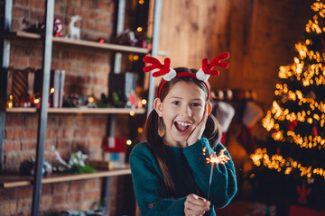 Photo of charming little girl excited hold bengal light dressed green christmas garment tradition...