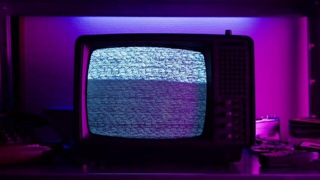 Retro TV, vintage television In a nostalgic setup, a retro TV displays grain on screen, scary halloween night device good for chroma key and green screen.