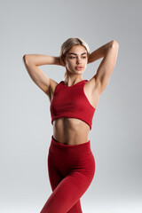 Sexy fitness woman. Beautiful athletic girl, isolated on the gray background