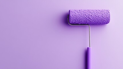 Obraz premium Paint roller covered with purple paint on a smooth purple background.