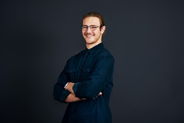Portrait, business or man with arms crossed, glasses or professional on dark background. Face, person or entrepreneur with creative agency, copywriting or eyewear with career ambition or mockup space